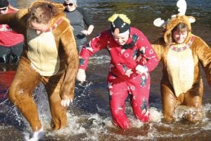 Above: Three “Moose” were spotted taking part in the November Storm Festival Wave Dash at Poplar River on Saturday, November 12. Right: Also taking part were, front to back, Molly O’Neill, Lee Bergstrom, Linda Jurek and Teri Chilfone, who does look quite chilly. About 50 people participated in the wave dash.