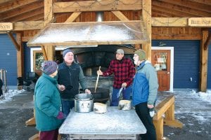 While classes were conducted inside the blue and red buildings at North House Folk School during Winterer’s Gathering, outside four hardy souls made enough chili in this huge pot to feed more than 160 people for supper on Saturday night. Dave and Amy Freeman gave a talk following the chili feed that attracted more than 200 folks interested in learning about Freeman’s one-year camping stay in the Boundary Waters Canoe Area (BWCA).