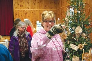 Laurie Bradley found this ornament for her tree at the Hovland Arts Festival Christmas sale held on Saturday, November 26. More than 100 people attended the event. Tables (and walls) were filled with handmade pottery, jewelry, pictures, birch bark bowls, wreaths and garlands and many other interesting items.