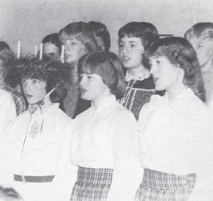 Heide Anderson, inset, was honored as the St. Lucia in 1981 during the annual Julefest ceremony at Bethlehem Lutheran Church which featured lots of Scandinavian goodies and other holiday festivities. Shown, from left, are Heide Anderson, Kim Clothier and Anna Mae Petek singing in front of members of the Son’s Rays.