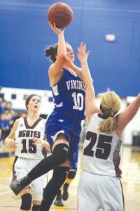 Far left: Wearing jersey number 10, Abbie Crawford displayed nice form when she went up for a lay-up against the Wrenshall Wrens. Above: In hot pursuit, Maya McHugh ran down the Wren ball handler and forced a turnover. Left: Blond hair trailing her, fast footed Sophie Eliasen drives for two points against the Wrens.