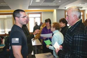 Greg Gentz (left) and Lloyd Speck talk after the county board meeting. The two men strongly encouraged commissioners to lower the proposed 2017 county levy from 19.88 percent to 9.9 percent.