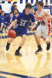 Above: Will Ramberg dribbled by his defender for a lay up. Right: Dyami Blackwell, guarded by No. 33, was the Vikings’ big scorer against Wrenshall.