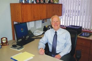 Mike LaVigne has a reason to smile. He will retire soon from his job as president of the Grand Marais State Bank after 33 years of service to the community.