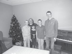 Above: Laura Laky and her talented piano students gave a wonderful holiday music recital for the residents on Dec. 23. Left: Santa and Mrs. Claus made a special visit to the Care Center on Christmas Eve, bringing gifts and good cheer to all the residents.