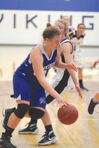 Far left: Showing off her ball handling skills, Vikings’ center Emily Jacobsen cuts to the basket against the Mariners. Jacobsen scored 24 points in the game. Above: Alyssa Spry (25) looks for a teammate to pass. Left: Jadzia Crow puts up a shot against the Silver Bay Mariners.