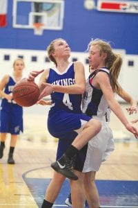 Above: Driving to the basket, Sarah Toftey didn’t have time to chat with the defender as she drove for two points. Left: Her “eyes on the prize,” Sophie Eliasen sails through the lane to score two points. Eliasen tallied 14 points against Cherry.