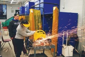 Sparks were flying the other day in the CCHS Industrial Arts room as the Robotics team began its six-week building of the robot. Billy Hackett looks on while Hannah Vander Heiden cuts metal for the robot’s frame. This year’s robot will do three tasks. One is to pick up and shoot balls through a target. The second is to place gears in a machine, and the third is to climb a rope.