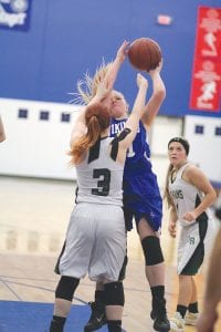 Far left: Sophie Eliasen doesn’t let a little foul stop her from shooting. Eliasen scored 32 points against Mesabi East. Above: Zoe Nonnemacher saw some varsity action recently, playing well at the guard spot. Left: Abbie Crawford put in two points on this play against Northeast Range.