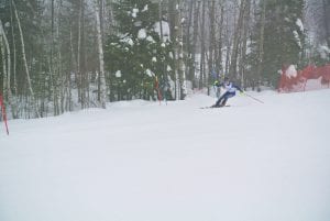 Logan Backstrom navigates sharp turns around gates to finish in sixth place at the Hibbing Invite.