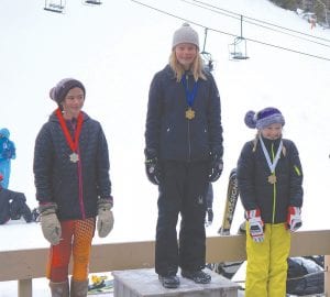 Above: Ella Sporn stands on the top spot of the podium after winning first place in the girls’ 12-13 age group at a Northland Junior Race held at Lutsen Mountains on February 5. Over 140 racers from across the Northland and Canada competed in the day-long races. Above right: Elliott (Zippy) Zimmer flew down the course and took first place in the Boys 5 and under race. Right: Staying in a nice tuck, Gus Hahn speeds around a gate.