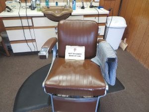 When Chuck Petek leaves on a break for lunch or coffee he places a sign on his barber chair and heads either home or to Blue Water Cafe, the hotspot for coffee. Patrons come in and wait for his return, usually reading a newspaper or magazine while holding their spot for the next haircut.