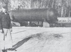 A 20-ton liquefied petroleum gas tank was put into use by the Grand Marais Bottle Gas Company in January 1960. Gene Nelson, manager of the company, said that increased business justified expansion of storage facilities. The tank has an 18,000-gallon capacity, whereas the old tank (shown in background, which will still be used) holds about 6,000 gallons. The new tank was fabricated in Memphis, Tennessee and transported here direct by truck.