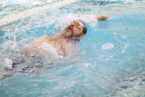 Eric Kemp is motoring through the water in the 100-yard Individual Medley (IM) which consists of swimming the breaststroke, backstroke, butterfly and freestyle strokes.