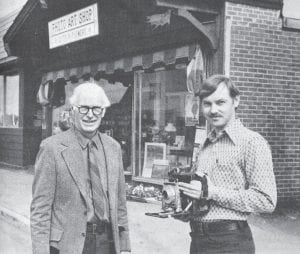 Shown in front of the Photo Art Shop as it changed hands on July 1, 1974, are Milford J. Humphrey, left, who founded the business 41 years prior, and Jim Larsen, the new owner. The shop was opened in 1933 as the G.M. Photo Service and has expanded over the years to include gifts, Christian literature, music supplies and a floral service. Jim and Jackie Larsen remain owners of the Wisconsin Street shop, which is known today as White Pine North.