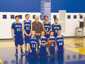 What does a 19-2 basketball team look like? Here they are, front row from L-R: Paul Dorr, Tate Crawford, Isaac Sandstrom, and Jacob Dorr. Back row L-R: Daunte Deschampe, Vaughn Swindlehurst, Coach Jacobsen, Kewadin Pierre, and Caide Northrup.