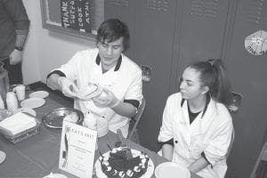 Seth Backlund and Brittany Franks dish up Sven & Ole’s soup and pizza. High school Culinary Arts students Cedric Rock and Lupita Mendivil served up a tasty dessert.