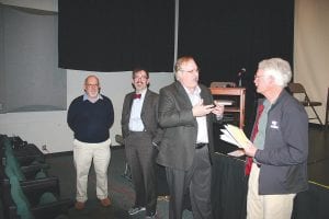 With Cook County Chamber of Commerce Director Jim Boyd (left) and Aaron Twait looking on, Cook County Assessor Todd Smith answers some questions for Mike Carlson (holding a fistful of papers) following the public meeting held to discuss Minnesota’s property tax system.