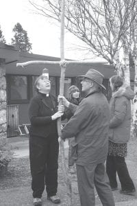 Pastor Beth Benson and Pastor Make Ditmanson hold the cross carried throughout town on the Cross Walk. About 30 people gathered at the Congregational United Church of Christ at 6 p.m. on Friday, April 14 to take part in the annual Cross Walk. Various people took turns carrying the wooden cross along the way, sometime singing songs of praise. Stops were also made where prayers were said. A service followed the walk at the Evangelical Free Church.