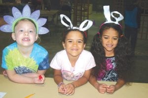 Waiting patiently to play one of the many games at the Community Center last Saturday before the Easter egg hunt was, from L-R: Payton Quaife, Scarlet Higgins and Alivia Higgins. The family fun event raised more than $1,000 for Kids Plus, a program that works with youth and families in the county.