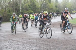 At left, participants in the 2016 race are seen as they come off Highway 61 and onto Lindskog Road.