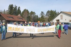 About 170 Cook County residents, young and old, joined the March for Science held Saturday, April 22. Starting at the Community Center, marchers, many of whom carried signs that read, “Science is not dead,” “Science not silence,” “We have no planet B,” or “Dear climate, you’ve changed,” walked through the streets of Grand Marais, ending at Harbor Park where Dr. Jean Cochrane, Dr. Seth Moore, Dr. Myron Schmidt, three young ladies (ages 9-10) from the Nordic Nature Group and Cook County Invasive Coordinator Amanda Weberg all spoke about the various ways science has made our lives better, from medicine, traditional knowledge of indigenous people, to electricity, to cleaning up the environment and more. Coordinating the event were Ann Bellman, Kathy McClure, Mary Sanders, and Jean Cochrane. While Chicago had 40,000 marchers, Cochrane noted that was less than 1 percent of their population. Cook County, with 5,200 residents, had 3 percent of its population turn out to join millions of people who took part in over 600 other marches worldwide on Earth Day.