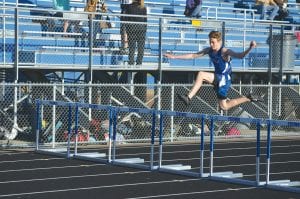 Above: Although Cook County doesn’t have a track to practice on, Jack Haussner has caught on to the hurdling technique and is posting some nice times in the 300-meter hurdles. Haussner placed 5th in that event at the Two Harbors track meet. Right: Warming up, from left to right are Kevin Viren, Jron Tamanaha, Leif Anderson, and running tall in back, Andy Kern.