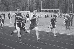 Top left: David Blackburn (R) battles to the finish line in the 100-meter run. Left: Anna Hay (R) pushes hard to catch the Carlton runner just ahead of her in the 200-meter dash. Above: Sam O’Phelan and Leif Anderson power down the finish line in the 400-meter run at the Esko Invitational track meet.