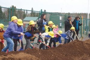 My how the dirt flew on May 16! Digging in and taking part in the ground breaking ceremony at the Grand Portage Community Center were 30-40 exuberant children. The kids and many adults in the community came out to celebrate the gift of $100,000 from the Minnesota Super Bowl Host Committee (MNSBHC) Legacy Fund that will be used to purchase new playground equipment at the Community Center.