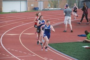 Above: Running strong, Malin Anderson (10) holds off some competitors as she heads down the straightaway. Left: Maya McHugh ran a fast 800-meter leg (2:40) in the girls’ 4x800 relay to help the Vikings take seventh place in that event.