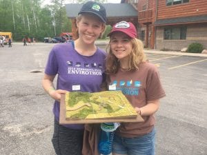 Lucy Callender (L) and Linnea Henrikson display a map of a wildlife management area that is adjacent to private property. Just how to manage the two to get the best results for the environment was one of the problems the kids had to solve at the state Envirothon competition.