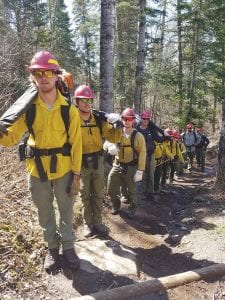 U.S. Forest Service fire fighting crews were recently on a training mission, carrying their heavy packs up and down the hilly trail along the Arrowhead River. Fire danger was recently high in the county, but two days of rain and very cool weather on May 17 and May 18 dampened any chance of a large forest fire in our neck of the woods.