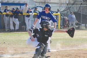 Above: Charging hard for home plate, Connor Somnis was safe all the way. The Vikings beat McGregor 2-1. Left: Andrew Miller pitched a gem of a game against Moose Lake/Willow River, striking out 12 batters. Despite his great effort, the Vikings fell in 9 innings 3-2.