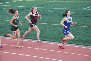 Above: Running strong, CCHS Junior Maya McHugh (7) leads the field in this 800-meter race. McHugh was the only Viking to win a Polar League Conference title, taking first in the 800-meter run in a time of 2:37 on a miserably cold day for running. Left: At the recent Esko track meet Chloe Blackburn runs for home with the baton in the 4x800-meter relay.