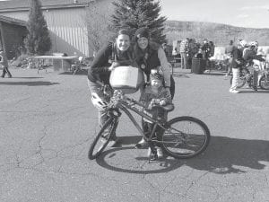 Ebba Nelson is one happy little girl! Ebba, pictured here between Moving Matters coordinator Maren Webb and her mom Jackie, won a bike at the bike rodeo that was held last Thursday, May 18. Because Ebba is still quite small and the bike is quite big, she will be able to swap it for credit at Fireweed Bike Co-Op, or if they want, she can get one she can use in the next few years.