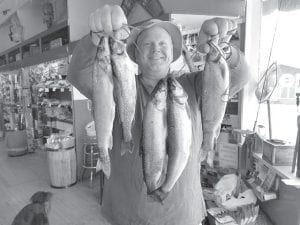 Top: Vince Ekroot didn’t win a darn thing in the Beaver House fishing contest but he doesn’t look like he could care less by the smile on his face as he holds this stringer of good eating trout. Above right: Chris Angelo holds up a nice stringer of walleye she entered into the Beaver House fishing contest. Chris won $500 for this catch, and $200 for her stringer of splake. Above left: Robyn (Ekroot) Tweeten won $500 for finishing first place in the splake division of the Beaver House fishing contest. Robyn, the daughter of Chris Angelo and Vince Ekroot, also earned $200 for finishing second place in the splake division in the Beaver House fishing contest.