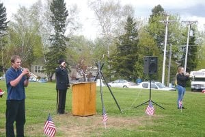 Tristen Bockovich and Melanie Smith played Taps at the Memorial Day service held on the courthouse lawn while American Legion Post 413 Commander Bob Mattson saluted.