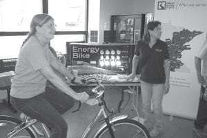 It was an “electric moment” for Kay Olson as she pedaled the Arrowhead Electric bike at last year’s annual meeting and made a light bulb come to life.