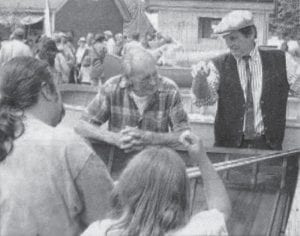 Longtime Lake Superior commercial fisherman and Grand Marais resident Tommy Eckel, center, was always an enthusiastic supporter of the North House Folk School and its activities, including the Wooden Boat Show. Here Eckel listens to a Canadian visitor at the 2006 boat show as they examine one of the many vessels on display. The Wooden Boat Show marks its 20th anniversary this year with fun and festivities beginning June 16 and continuing through June 18.