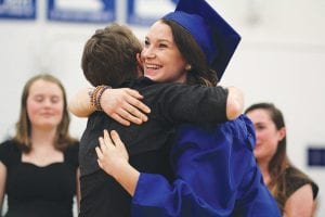 Hannah VanderHeiden, the only senior to sing in the choir this year, received a big hug from choir director Erica Ternes.