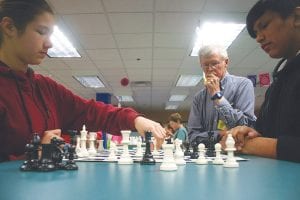 Above: Mike Carlson looks on as Arianna Poyirier and Angel Burnett strive to make the next, best move. Right: Things looked bleak but there was no giving up as Elaina Deschampe was down to just her king, but she wasn’t giving up. The best she could hope for was a stalemate, but sadly, that wasn’t to be in this game.