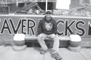 Tyson Cronberg, owner of the Beaver House, came out front last Saturday to check out the whimsical new hand crafted cedar Bobber Bench that offers visitors a place to rest in front of his store. The unique bench was funded through the Great Place Projects.