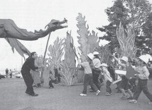 The Good Harbor Hill Players perform a scene from “Ohh, But The Fire Went Wild” at the 2007 Summer Solstice Pageant at North House Folk School. As seen above, little “hot shots” battle the fire dragon and his flames as part of the re-enactment of the Ham Lake Fire, which occurred earlier that spring.