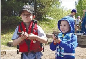 Above: What’s more precious than gold? Why that would be the fish Wyatt (left) and Cullen Sandstrom caught and are holding. Left: Jake Carleen holds up the giant rainbow trout that Wyatt caught. Wyatt’s fish was the biggest one taken all day.