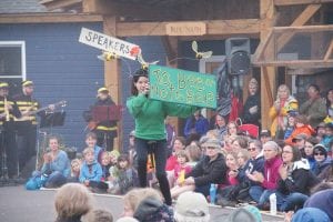 Things were buzzing at this year’s Summer Solstice Pageant held at North House Folk School in conjunction with the Wooden Boat Show. Top: A young lady holds a sign that says it all. Above: A wily bear tries to plead for honey. Left: Dancing bees and folks holding up flowers the bees came to pollinate. The show was put on once again by the Good Harbor Hill Players.