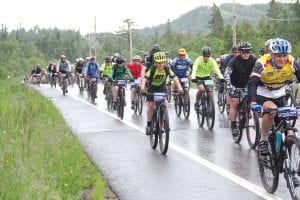 And they are off! Racers in the Lutsen 99er got to start by coasting downhill for a about a mile before they quickly found rain slicked muddy trails they navigated as they made their way back to the finish line. Some 1,800 riders took part in four different races on Saturday, June 24. On and off again rain made the race interesting for these mountain bike riders, who are used to such difficulties.