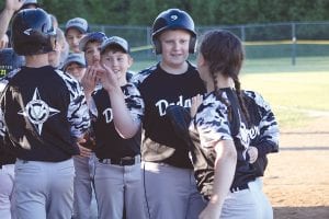 The Dodgers line up to high five Paul Dorr (on the left), who hit a home run.