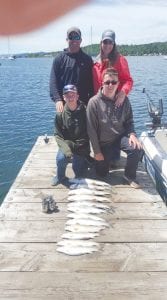 Captain Kelly Shepard of North Shore Outdoors took the Rob Hoen family fishing recently and they are proudly displaying their catch on the dock at the Grand Marais harbor. A dozen lake trout wait to be cleaned and then, presumably, some cooked for a delicious meal. The Hoens are from Longville, Minnesota.