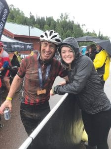 Madi Joynes gives her dad, Jim, a hug after he completed the Lutsen 99er. A bit muddy but none the worse for the wear, Jim finished second in his age class in the prestigious mountain bike race.