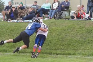 In the battle of the “two Dans,” Danny Ford made a spectacular catch and kept his toes just inside the out of bounds line as he was being hit by Dan LaVigne. Note the looks on the faces of those sitting behind the play.